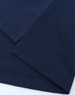 A close-up of navy blue fabric featuring stitched hems, showcasing the texture and quality of a polo shirt.
