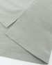 A close-up of a grey high-performance polo shirt, highlighting the fabric texture and neatly stitched hems.