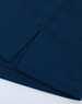 A close-up of a navy ultrafine cotton pique polo, featuring textured fabric and clean hems.