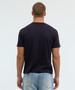 A black T-shirt viewed from the back, featuring a simple design and a logo. The model is wearing light blue jeans.
