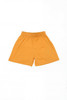 Youth Core Shorts in bright orange, featuring an elastic waistband and a simple design. It includes a logo.