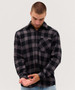 A long sleeve button-up shirt in black and grey plaid, featuring a chest pocket and a logo.