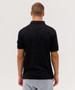 A black polo shirt with a classic collar and short sleeves, featuring a logo on the chest.