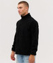 A black fleece jacket with a full zip and a high collar, displayed on a model standing sideways.