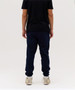 Navy track pants with elastic cuffs, paired with a black T-shirt and white sneakers. The pants have a logo on them.