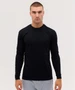A long sleeve black tee features a fitted design and includes a logo. Model is wearing grey pants.