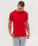 A red t-shirt is worn by a model looking down, paired with grey sweatpants. The shirt features a logo.