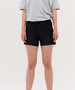 Black running shorts with an elastic waistband and side pockets, modelled by a person wearing a grey top.