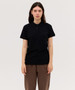 A black women's polo shirt with a collar, short sleeves, and a logo on the chest, displayed on a model.