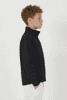 A black softshell jacket designed for youth, featuring a high collar and discreet branding.