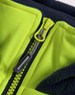 A close-up of a bright yellow zipper on a hooded puffer vest with a navy fleece lining. It has a branding logo.