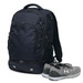 A navy backpack with multiple pockets, accompanied by a pair of grey sports shoes. The bag has a logo.