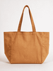 A large, caramel-coloured canvas tote bag with two handles and a side pocket. The bag features a logo.