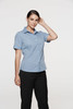 A short-sleeve button-up shirt in blue, worn by a model. The shirt features a collar and is tailored for a fitted look.