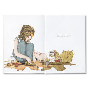 Inside spread from "Maybe" a children's illustrated book  by Kobi Yamada and Gabriella Barouch that shows a child with her pig friend, working on a project with extra large fall leaves. The copy on the page reads, "You already have everything it takes to do big things."