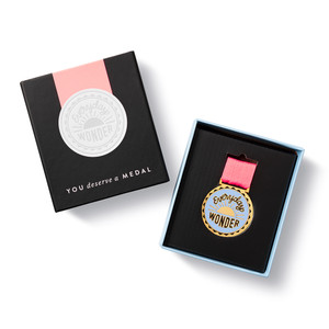 Open box with front of box, and front of medal. 