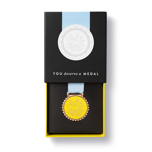 Half open box, showing half of the front of the medal. 