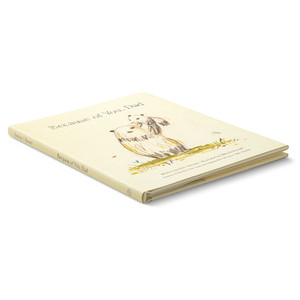 Side angled view of the front cover of the illustrated hardcover gift book with the title, Because of You, Dad. The cover features a father bear holding up a cub into the air.