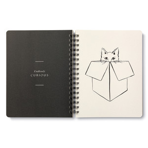 Inside this spiral notebook are 3 breakout pages with inspiring statements. The right side of this divider page features a line drawing of a cat peeking its head out of a box and on the left side is the statement "Endlessly Curious" on a black background.