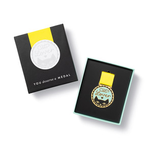 Open box view,  an award medal with a yellow ribbon and an illustration that reads “Cat Lover.”, includes keepsake gift box, black slip cover with medal image in cover, medal sits securely in tray box
