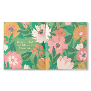 An inside page from the women empowerment gift book, "She...". This page has a pink, peach, and green floral pattern with copy that reads, "She is an artist and life is her canvas."