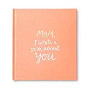 Front cover of the fill-in gift book, Mom, I Wrote A Book About You. A personalized gift book to celebrate mom on mother's day. The cover is light orange and has the title printed in gold and white foil.