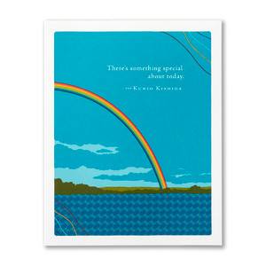 The front of this birthday card features an illustration by Jessica Phoenix and has a bright rainbow in a scene with a lake and blue sky with scattered clouds background, and the quote "There's something special about today." -Kunio Kishida