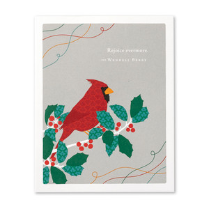 The front of this holiday card features an illustration by Jessica Phoenix and has a  red cardinal sitting on a branch with holly berries, and the quote "Rejoice evermore." -Wendell Berry