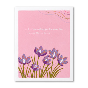The front of this birthday card features an illustration by Jessica Phoenix and has a pink background with a group of wild flowers blowing in the breeze, and the quote “…there’s something good in every day.” —Alice Morse Earle
