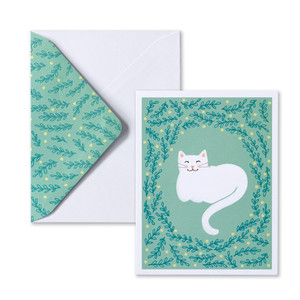 Front view of the card design and envelope. The card front has a sweet, cuddly cat on a teal background with leafy green border  and the envelope is white with a teal leafy pattern on the envelope flap.