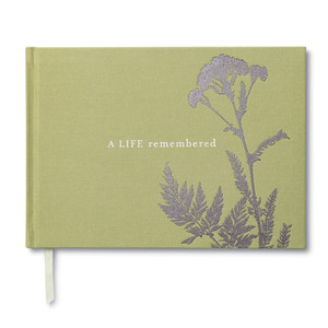 Front cover of a memorial, sympathy guest book. The cover is sage green and has a a simply plant design that is foiled and the title, A Life Remembered.