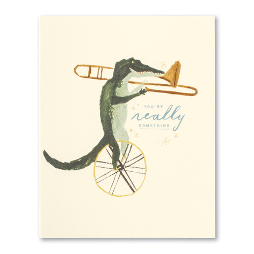 The front of this card has the picture of an alligator riding a unicycle playing a trumpet, and a beige background with the title, "You're really something.". 