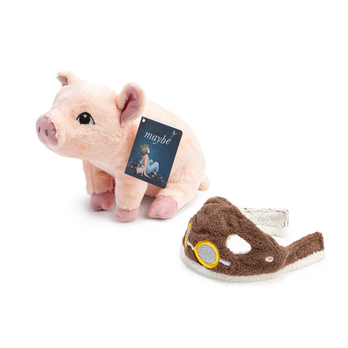 Flying pig plush without helmet, and helmet sitting at its side, along with the children's book Maybe at its side. 