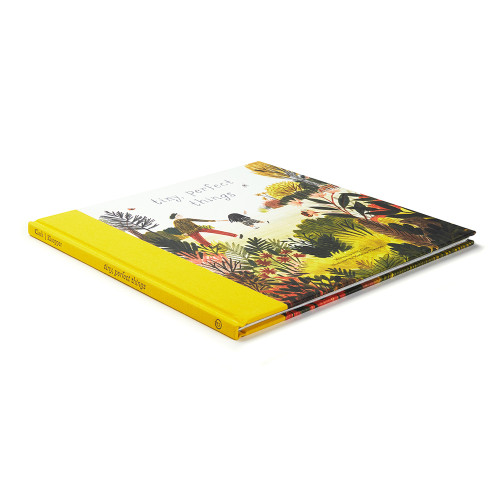 Side view of Tiny, Perfect Things, showing the spine and front of the book. 