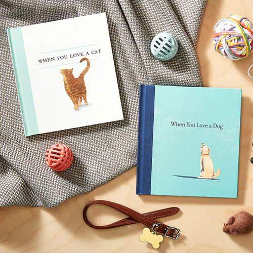 A lifestyle photo of the sweet gift book "When You Love a Dog" and "When You Love a Cat", adorable books to express your love of your pet with sweet illustration by Jessice Phoenix and written by M.H. Clark. 