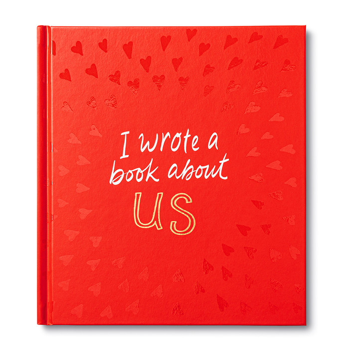 Front cover of the fill-in gift book for your special someone, I Wrote A Book About Us.  The cover is read and has the title printed in gold and white foil.