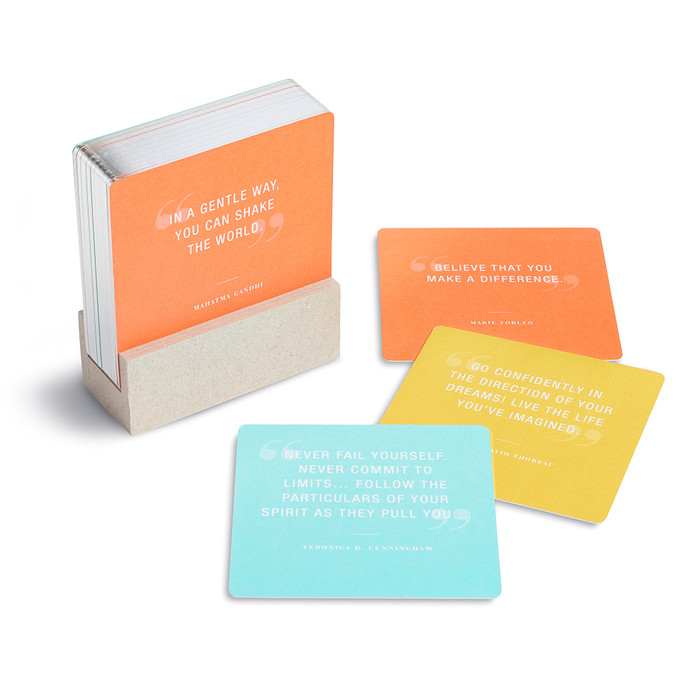 Set of cards in stand, and spread out on the side. 