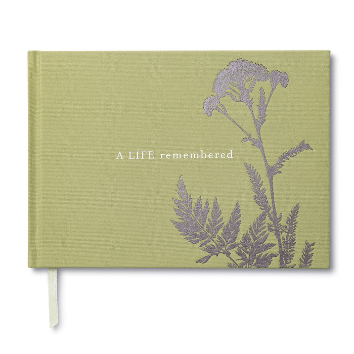 Front cover of a memorial, sympathy guest book. The cover is sage green and has a a simply plant design that is foiled and the title, A Life Remembered.