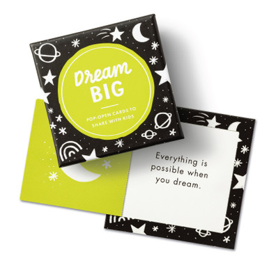 This image shows the front box cover of the "Dream Big" ThoughtFulls for kids pop open cards. There's an open card with a statement that reads "Everything is possible when you dream." The box and card design has a black background with a neon green and white cosmic pattern.