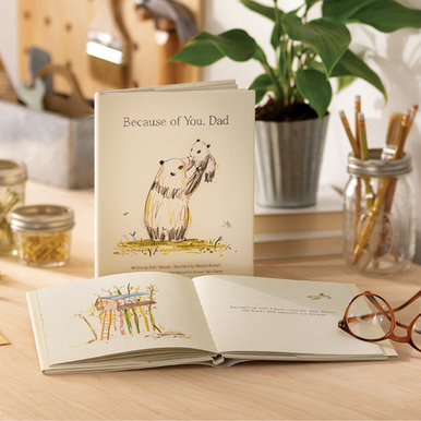 Lifestyle photo of "Because of You, Dad" written by Kobi Yamada and illstrated by Natalie Russell. Image shows a page from the book that says "Because of you, I have someone who shares my hopes and supports my dreams."