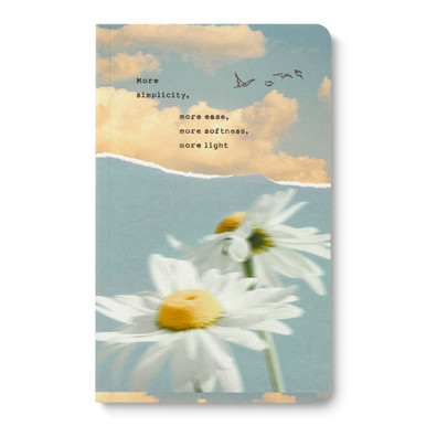 The front cover of this softcover journal features an illustration of a sky with clouds and two daisies. The cover statement reads, "More simplicity, more ease, more softness, more light"