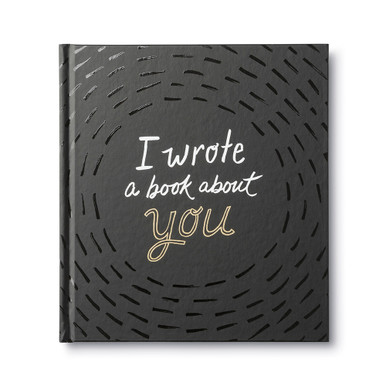 Front cover view of "I Wrote a Book About You", a fill-in-the-blank gift book written by M.H. Clark. The cover design is black with the title printed in gold and white foil.