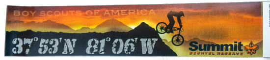 Rectangular bumper sticker with an orange sunset with the wording, Boy Scouts of America at the top, a mountain range with a mountain biker, the Summit coordinance and the Summit logo.