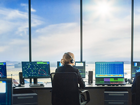 Aircraft dispatcher working at computer