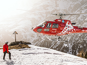 Helicopter landing on snow covered mountain