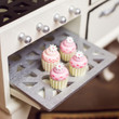 In 18" doll kitchen the four mini cupcakes are coming out of oven rack. In 18" doll kitchen the four mini cupcakes are coming out of oven rack.