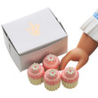 Against white background a doll hand reaches for one of the 4 cupcakes. Against white background a doll hand reaches for one of the 4 cupcakes.