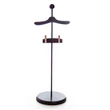 A single dark brown wooden clothing display stand designed to fit American Girl® doll clothing is centered against a solid white background. The stand features a smooth, circular base, a slender metal vertical rod, a top section shaped like a coat hanger, and a lower horizontal bar equipped with two clothing clips.