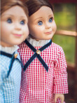 In outdoor scene, 18 inch Laura doll stands with her sister Mary in matching blue check 18 inch dress.
