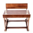 Front view of a miniature wooden pioneer school desk with two pens standing in its ink wells.